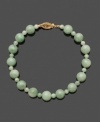 Simple and clean, this look is always in style. Bracelet features round jade beads (4 mm and 8 mm) with a 14k gold clasp. Approximate length: 7-1/2 inches.
