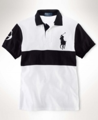 vChanneling iconic, sporty style with bold pieced detailing, a handsome short-sleeved polo is cut for a trim, modern fit from breathable cotton mesh. vChanneling iconic, sporty style with bold pieced detailing, a handsome short-sleeved polo is cut for a trim, modern fit from breathable cotton mesh.