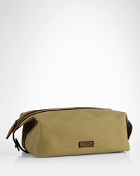 An impeccably stylish carrying case for the modern gentleman, this lightweight pouch provides sharp transport for essential toiletries in a leather-trimmed canvas construction. An impeccably stylish carrying case for the modern gentleman, this lightweight pouch provides sharp transport for essential toiletries in a leather-trimmed canvas construction.
