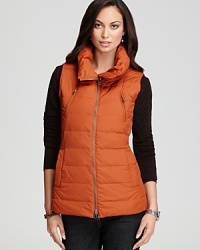Give your style a sense of adventure with a plush Eileen Fisher down vest, accented with zip accents and a stand collar for utilitarian chic. Give your style a sense of adventure with a plush Eileen Fisher down vest, accented with zip accents and a stand collar for utilitarian chic.