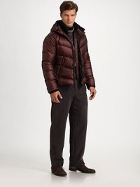 A sporty, sophisticated puffer style featuring an attached hood for added warmth.Zip frontAttached hoodSide slash zipper pocketsRemovable vest insertAbout 24 from shoulder to hemNylonDry cleanImported