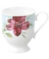 Painterly lilies bloom around this footed porcelain mug, creating a beautiful arrangement with the rest of Oleg Cassini's Sweet Blossom dinnerware.