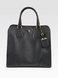 Saffiano leather in a luxe frame-top carryall.Double top handles, 5 dropDetachable shoulder strapTop snap closureMetal lettering logo on saffiano leather baseProtective metal feetOne inside zip pocketOne inside open pocketLeather lining12½W X 12H X 6½DMade in Italy Saffiano leather in a luxe frame-top carryall.Double top handles, 5 dropDetachable shoulder strapTop snap closureMetal lettering logo on saffiano leather baseProtective metal feetOne inside zip pocketOne inside open pocketLeather lining12½W X 12H X 6½DMade in Italy