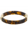 Beat the heat in this sunglass-inspired style. Michael Kors incorporates tortoise shell hues in this trendy bangle bracelet. Crafted in gold tone mixed metal and acetate with a slip-on hinge clasp. Approximate diameter: 2-1/2 inches.
