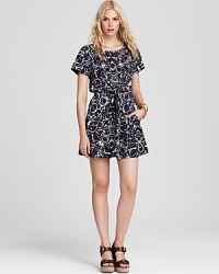 Send your summer style on a global excursion with this ikat-print Juicy Couture sundress, accented with a tie waist for feminine appeal. Add stacked bangles and natural wedges for a traveler-chic look. Send your summer style on a global excursion with this ikat-print Juicy Couture sundress, accented with a tie waist for feminine appeal. Add stacked bangles and natural wedges for a traveler-chic look.
