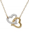 Heart of gold: Add a sentimental accent to your look with Swarovski's interlocking crystal heart pendant. Crafted in gold tone mixed metal. Approximate length: 15 inches. Approximate drop: 1 inch.
