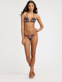 Abstract lotus flowers create a beautiful backdrop to this stretch swim style with bohemian bead details. Triangle cupsDouble halter strap ties at neckBack tie closureBead detailsStretch bottom with string sidesFully lined80% nylon/20% spandexHand washMade in USA of Italian fabric Abstract lotus flowers create a beautiful backdrop to this stretch swim style with bohemian bead details. Triangle cupsDouble halter strap ties at neckBack tie closureBead detailsStretch bottom with string sidesFully lined80% nylon/20% spandexHand washMade in USA of Italian fabric