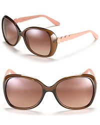 Circular detail at temples add an edgy style to these glamorous oversized sunglasses from MARC BY MARC JACOBS.