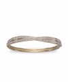 All the sparkle you love, with a twist. This stunning Swarovski bangle shines with clear crystal pave set in two bands of gold-plated mixed metal crossed at center. Approximate diameter: 3-1/4 inches.