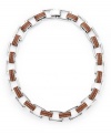 Industrial chic. This eclectic necklace from the Lauren Ralph Lauren collection features heavy rectangular links in concert with a trendy leather band. Set in silver tone mixed metal. Approximate length: 18 inches.