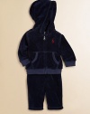 This coordinating athletic set includes a classic full-zip hoodie and a matching sweatpant in soft, cozy velour. Hoodie Attached hoodLong sleevesFull-zip frontSplit kangaroo pocketRibbed cuffs and hem Sweatpants Elasticized waist with tieMock fly87% cotton/13% polyesterMachine washImported