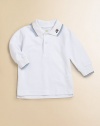 The classic pique cotton polo shirt gets a darling update with contrast trim and dumptruck embroidery.Shirt collarLong sleevesButton frontUneven side vented hemCottonMachine washImported Please note: Number of buttons may vary depending on size ordered. 