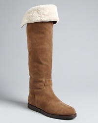 Luxury meets casual ease in these Salvatore Ferragamo tall flat boots, finished off with touches of shearling. Luxury meets casual ease in these Salvatore Ferragamo tall flat boots, finished off with touches of shearling.