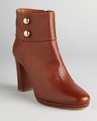 These commanding booties spell sophistication; metallic, military inspired buttons add some dash; from kate spade new york. These commanding booties spell sophistication; metallic, military inspired buttons add some dash; from kate spade new york.