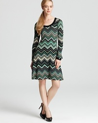 With a nod to the '70s, this Karen Kane dress makes a graphic impact with a bold zigzag print. Flared sleeves finish the style with retro charm. With a nod to the '70s, this Karen Kane dress makes a graphic impact with a bold zigzag print. Flared sleeves finish the style with retro charm.