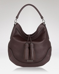 Burberry impresses with a new design classic. Crafted from luxurious leather with modern tassel trims, this shoulder-sized bag promises to garner plenty of compliments from the sartorially savvy. Burberry impresses with a new design classic. Crafted from luxurious leather with modern tassel trims, this shoulder-sized bag promises to garner plenty of compliments from the sartorially savvy.