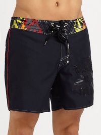 Colorful graphic prints adorn this quick-drying, cropped swim style.Drawstring tie waistRear patch pocketInseam, about 7PolyesterMachine washImported Colorful graphic prints adorn this quick-drying, cropped swim style.Drawstring tie waistRear patch pocketInseam, about 7PolyesterMachine washImported