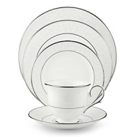 With enameled pearl-like dots, an opalescent background, and the innocence of bone china, Opal Innocence is a romantic pattern of understated elegance. Two bands of platinum a slightly wider one on the rim, kissing a thin fluted design, and a narrower one inside the border adorn each plate. The cup bears additional platinum on its graceful handle and another band at midpoint. Each piece is decorated with a flowing, white-on-white vine design peppered with enamel dots. This service creates a splendid formal table setting and, because of its neutral coloring, works well with any table décor.