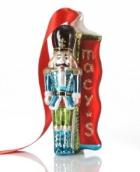 Macy's Soldier ornament stands by to protect presents from overeager children. He poses beside the store's holiday banner in brilliant red, blue and green glass. Macy's Soldier ornament stands by to protect presents from overeager children. He poses beside the store's holiday banner in brilliant red, blue and green glass.