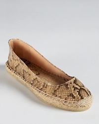 Python embossed leather dresses up a flat espadrille silhouette from Andre Assous. Python embossed leather dresses up a flat espadrille silhouette from Andre Assous.