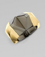 A shiny, two-tone geometric design for a futuristic look. BrassDiameter, about 2Hinged closureMade in Italy