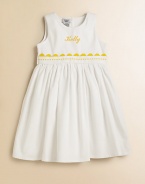 A classic look for adorable girls everywhere, shaped from soft cotton piqué with a ribbon waist and yellow rick-rack trim. Back button closure Gathered empire waist Cotton Machine wash Made in USA FOR PERSONALIZATION Select a quantity, then scroll down and click on PERSONALIZE & ADD TO BAG to choose and preview your personalization options. Please allow 2 weeks for delivery.