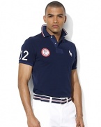 A trim-fitting short-sleeved polo shirt is rendered in breathable cotton mesh with bold country embroidery, celebrating Team USA's participation in the 2012 Paralympic Games.