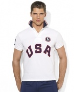 Cut for a trim, modern fit from breathable cotton mesh, a short-sleeved polo shirt is accented with bold country embroidery, celebrating Team USA's participation in the 2012 Olympic Games.