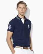 Designed exclusively for Ralph Lauren's collection celebrating the Wimbledon Championships, an iconic short-sleeved polo shirt is cut for a trim, athletic fit from a breathable cotton-blend mesh for comfort on and off the court.