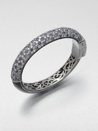 Half of this shimmering bangle is encrusted with gemstones in icy cool colors, the other half is finished in sleek enamel, and inside is lovely, lacy openwork.Blue sapphire, white topaz and blue topazEnamelBlack rhodium-plated sterling silverDiameter, about 2.2Hinged with push-lock claspImported Half of this shimmering bangle is encrusted with gemstones in icy cool colors, the other half is finished in sleek enamel, and inside is lovely, lacy openwork.Blue sapphire, white topaz and blue topazEnamelBlack rhodium-plated sterling silverDiameter, about 2.2Hinged with push-lock claspImported