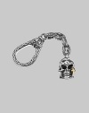 Skull-motif charm with a solid 18k gold cross accent on an engraved sterling silver clasp. About 4 long Made in USA