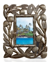 Carved with the bounty of Haiti's all-important breadfruit tree, this hand-cut and hammered picture frame tells a unique story in cleverly re-purposed steel. Carved with the bounty of Haiti's all-important breadfruit tree, this hand-cut and hammered picture frame tells a unique story in cleverly re-purposed steel.