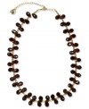 A casual-chic necklace in neutral hues from Jones New York. Clusters of brown resin beads are strung on a gold-tone linked chain. Crafted in worn gold tone mixed metal. Approximate length: 17 inches + 3-1/2-inch extender.