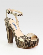 Python adjustable ankle strap style with a wood platform and heel. Wooden heel, 5 (125mm)Wooden platform, 1 (25mm)Compares to a 4 heel (100mm)Python upperLeather lining and solePadded insoleMade in ItalyOUR FIT MODEL RECOMMENDS ordering one half size up as this style runs small. 