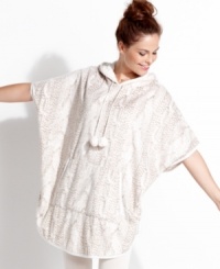 Roomy, breezy style. Kensie's poncho is easy to wear and features convenient kangaroo pockets, a loose hood and pom-pom ties. Roomy, breezy style. Kensie's poncho is easy to wear and features convenient kangaroo pockets, a loose hood and pom-pom ties.