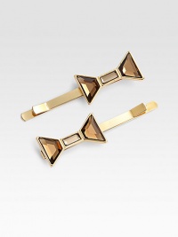 A large, glass bow sits atop a 10k gold-plated bobby pin.10k gold platingGlass bowBrass & steel baseImported A large, glass bow sits atop a 10k gold-plated bobby pin.10k gold platingGlass bowBrass & steel baseImported