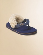 A cozy twist on the favorite flip flop, with a back strap lined in fluffy sheepskin to keep them on tiny feet.Rubber thong upperSheepskin-lined back strap with elastic tabsRubber soleRaised logo on thongImported