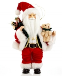 Hard at work and dressed in his traditional attire, Santa preps for the Christmas season with piles of toys in his arms for all the good little boys and girls. Hard at work and dressed in his traditional attire, Santa preps for the Christmas season with piles of toys in his arms for all the good little boys and girls.