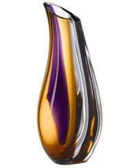 With the extraordinary beauty and grace of an orchid blossom, this Kosta Boda vase adds brilliant artistry to modern interiors. Luxurious art glass handcrafted in a wide, fluid shape glistens with streaks of rich violet and warm amber. With the extraordinary beauty and grace of an orchid blossom, this Kosta Boda vase adds brilliant artistry to modern interiors. Luxurious art glass handcrafted in a wide, fluid shape glistens with streaks of rich violet and warm amber.