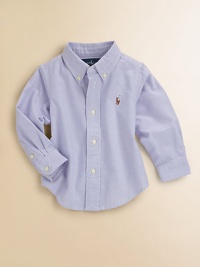 A classic button-down design is crafted in vibrant woven cotton for a clean, preppy style.Button-down collarLong sleeves with barrel cuffsButton-frontBox-pleated backShirttail hemCottonMachine washImported Please note: Number of buttons may vary depending on size ordered. 