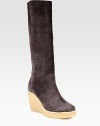 Supremely soft suede knee-high boot has an ultra-high wedge and slight platform. Rubber wedge, 4 (100mm)Rubber platform, 1 (25mm)Compares to a 3 heel (75mm)Shaft, 15Leg circumference, 14Suede upperPull-on styleLeather liningRubber solePadded insoleMade in ItalyOUR FIT MODEL RECOMMENDS ordering one half size up as this style runs small. 