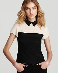 Monochrome color blocking lends statement style to this Nanette Lepore top in luxe silk. A contrast collar lends a whimsical finish. Monochrome color blocking lends statement style to this Nanette Lepore top in luxe silk. A contrast collar lends a whimsical finish.