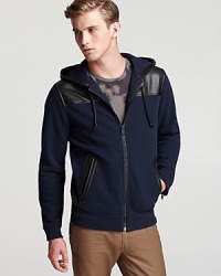 Leather accents elevate this sweatshirt from laid-back to luxury, a perfect complement to your casual cool wardrobe. Leather accents elevate this sweatshirt from laid-back to luxury, a perfect complement to your casual cool wardrobe.