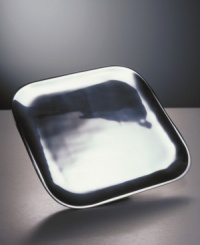 Graceful, imaginative, award-winning contemporary design distinguishes Nambé gifts and collectibles. Each item is designed by an artist as a personal expression of balance in form, beauty in materials, and precise function. The exquisitely simple 11 square serving plate is cleanly styled in cast metal, with a polished, mirror-bright finish.