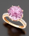 An intriguing feminine design. A round-cut pink amethyst (6-3/4 ct. t.w.) in a 14k rose gold setting with twinkling diamond accents on both sides of the band.