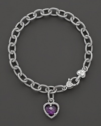 A faceted purple crystal heart charm decorates a classic bracelet from Judith Ripka. A faceted purple crystal heart charm decorates a classic bracelet from Judith Ripka.