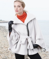 Calvin Klein gives a refined, minimalist look to outerwear with this chic cape. The faux-leather trim adds appealing edge. Calvin Klein gives a refined, minimalist look to outerwear with this chic cape. The faux-leather trim adds appealing edge.