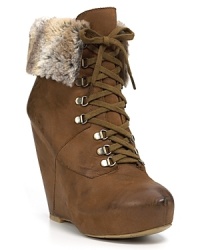 Faux fur lining softens these rugged lace-up booties for sky-high chic when temperatures fall. By Boutique 9. Faux fur lining softens these rugged lace-up booties for sky-high chic when temperatures fall. By Boutique 9.