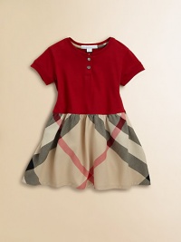 Crafted in ultra-soft cotton with snap detail, this stylish, short-sleeved frock has a full, check skirt.CrewneckShort sleevesPullover styleDrop-waistCottonMachine washImported Crafted in ultra-soft cotton with snap detail, this stylish, short-sleeved frock has a full, check skirt.CrewneckShort sleevesPullover styleDrop-waistCottonMachine washImported