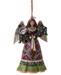 A peace offering for your tree, this beautiful angel ornament is draped with a lush garland of fruit and holly. Elaborate folk-art details in her skirt and rich colors throughout make it a Jim Shore classic. A peace offering for your tree, this beautiful angel ornament is draped with a lush garland of fruit and holly. Elaborate folk-art details in her skirt and rich colors throughout make it a Jim Shore classic.